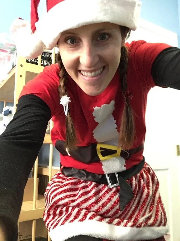Dr. Gelnett in a Santa hat and pigtails at holiday time